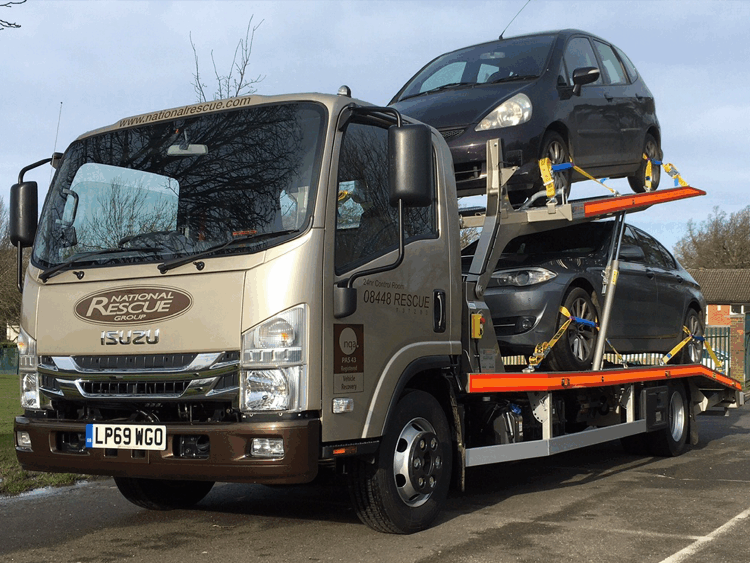 A National Rescue Group tow truck is transporting two cars